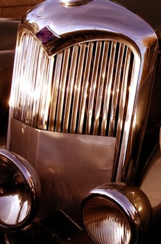 The front grill and headlight of the old beautiful car on the background copy space, card background, multimedia content creation