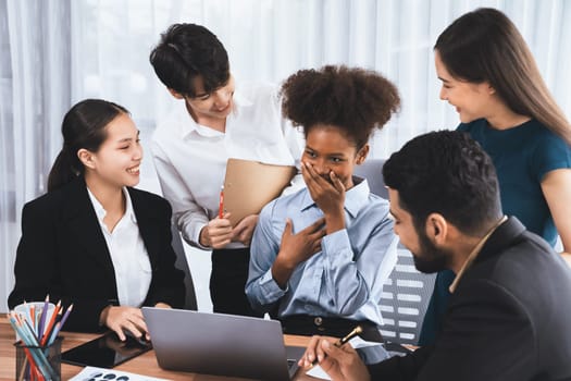 Happy diverse business people work together, discussing in corporate office. Professional and diversity teamwork discuss business plan on desk with laptop. Modern multicultural office worker. Concord