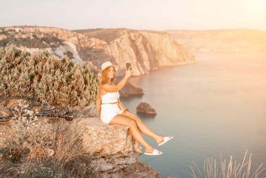 Selfie woman in cap and tank top making selfie shot mobile phone post photo social network outdoors on sea background beach people vacation lifestyle travel concept