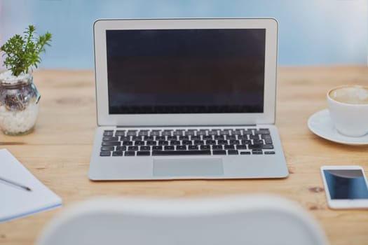 Laptop, desk and workspace in office room with mockup space, phone or coffee for productivity. Interior, technology or notebook with plants at empty workplace for business, online career or marketing.