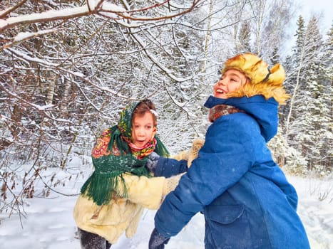 Two cute happy little cheerful children having fun in winter snow forest. Photo shoot in stylized clothes of the USSR. Fur Hat with earflaps
