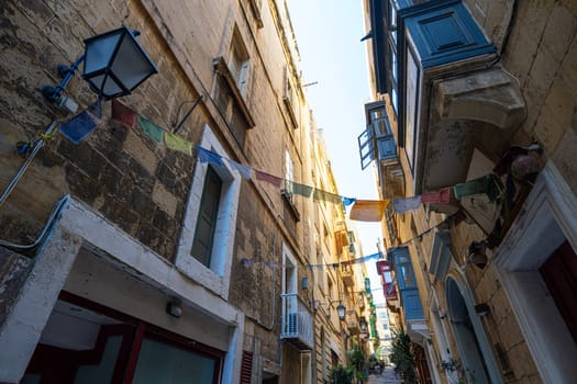 Valletta, Malta, April 03, 2024. Tibetan flag  prayers hung in a narrow street of the city center