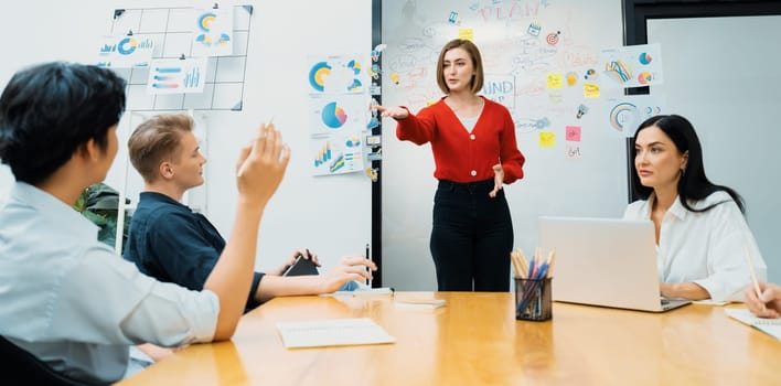 Closeup image of male project manager raise hand to ask questions while young beautiful leader presents business project with confident by using mind map and colorful sticky notes. Immaculate.