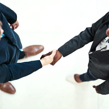 Handshake, meeting and welcome with business people in office for agreement or deal from above. Corporate, b2b partnership or thank you with employee team shaking hands in workplace for contract.