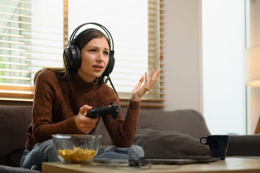Upset young woman feeling disappointed losing online video games.