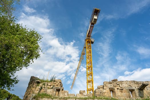 Construction crane working on large construction site