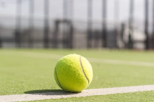 Tennis ball on a tennis court next to the side line. High quality photo