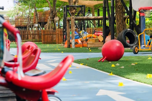 Red tricycle in the park, children's playground in the park