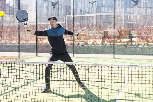 man playing paddle tennis at indoors pitch. High quality photo