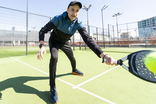 Man playing paddle tennis. Jumping and shooting the ball. High quality photo