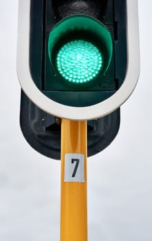 Green traffic light, city or outdoor sign for control, movement or rules for safety on urban street. Go symbol, background or icon for road, sidewalk or signal for public or transportation in town.