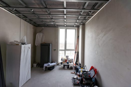 Workers are installing plasterboard (drywall) for gypsum walls in apartment is under construction, remodeling, renovation, extension, restoration and reconstruction. High quality photo