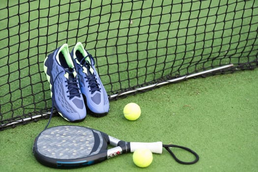 Padel tennis racket sport court and balls. Download a high quality photo with paddle for the design of a sports app or soical media advertisement. High quality photo