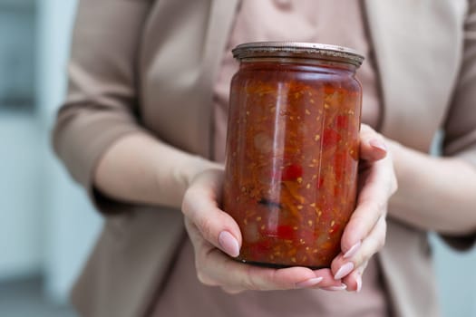 vegetable lecho in a glass jar on a white background. High quality photo