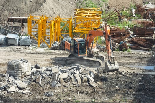 Aerial view Hydraulic scissors on rigging to cut abandoned buildings destroy building, Hydraulic scissors on rig of crane cut building on construction site. High quality photo