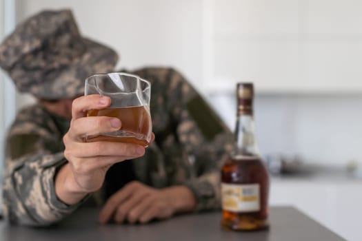 close up portrait of alcoholic wasted man sleeping drunk looking at whiskey glass avoiding temptation thinking of alcohol addiction , drinking abuse , alcoholism concept isolated on black background. High quality photo