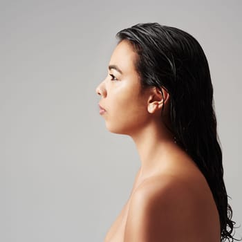 Woman, profile and beauty with haircare, cosmetics or salon on a gray studio background. Young female person or model with wet hair or shower in spa wash, hygiene or keratin treatment on mockup space.