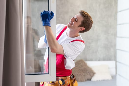A repairman fixing windows in new apartment