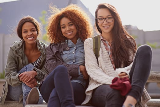 Portrait, female learners and friends of campus, break and relax for classes at university. Face, happy and diversity at school and education for women student, academics and learning at college.