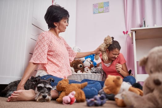 Mother, child and playing with teddy bear in home for bonding connection in bedroom, parenting or toys. Mature woman, teenager and funny together with animal dog for relax love, care or happiness.