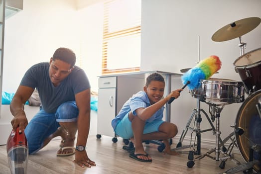 Father, portrait or child cleaning by vacuum floor of home as teamwork to learning responsibility in house chores. Family, single parent or kid with duster or helping with drums or dirty instruments.