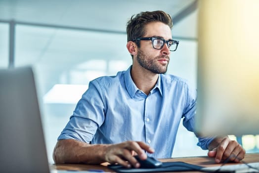 Computer, employee and man in office, copywriter and smile for job, startup and workplace of business. Happiness, staff and person with technology, desktop and glasses with confidence and pride.