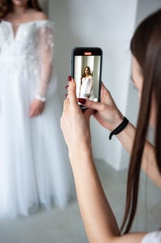 portrait of beautiful young woman in white wedding dress posing in studio