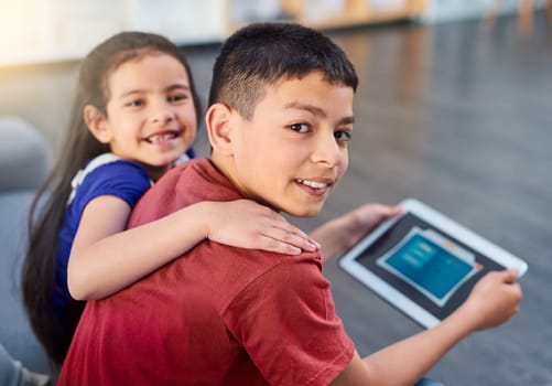 Tablet, kids and portrait with siblings on couch, online and esports for entertainment. Technology, streaming and smile for play on internet in lounge, gaming and digital or mobile app on touchscreen.