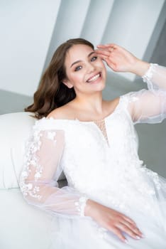 portrait of beautiful young woman in white wedding dress posing in studio