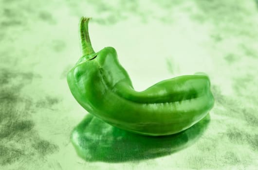 Sweet green chili pepper also known as the golden Greek pepper or Tuscan pepper on bright background ,used as ingredient in salads and compotes