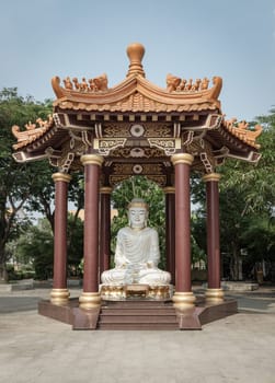 Bangkok, Thailand - Apr 11, 2024 - White Jade Gautama Buddha Statue Sitting on Lotus in pavilion. The Shakyamuni Meditating Buddha at Fo Guang Shan Thaihua Temple, Space for text, Selective focus.