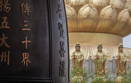 Bangkok, Thailand - Apr 11, 2024 - Chinese lettering on Traditional Chinese Big drum and Golden statue goddess of Mercy Guanyin or Quan Yin statue on background at Fo Guang Shan Thaihua Temple. Space for text, Selective focus.