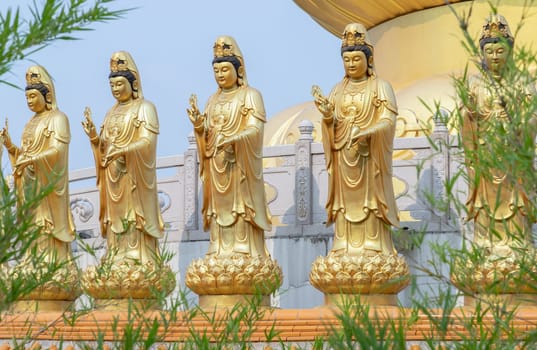 Bangkok, Thailand - Apr 11, 2024 - Golden statue goddess of Mercy Guanyin or Quan Yin statue at Fo Guang Shan Thaihua Temple. Guan Yin Buddha, Taiwanese temple style, Space for text, Selective focus.