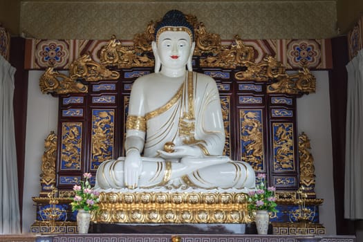Bangkok, Thailand - Apr 11, 2024 - White Gautama Buddha Statue Sitting on Lotus. The Shakyamuni Meditating Buddha at Fo Guang Shan Thaihua Temple, Space for text, Selective focus.