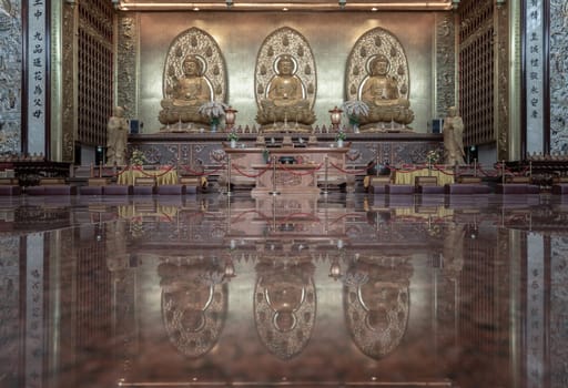 Bangkok, Thailand - Apr 11, 2024 - Three Buddha images inside Fo Guang Shan Thaihua Temple is famous place. Taiwanese temple style, The Institute of Buddhism, Space for text, Selective focus.