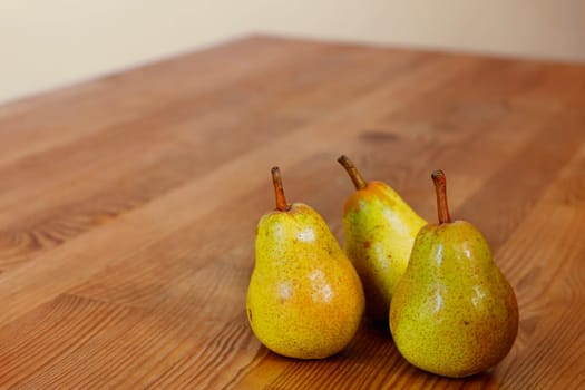 Yellow pears on wooden table ready to eat