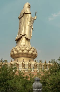 Bangkok, Thailand - Apr 11, 2024 - Big Golden statue goddess of Mercy Guanyin or Quan Yin statue at Fo Guang Shan Thaihua Temple. Guan Yin Buddha, Taiwanese temple style, Copy space, Selective focus.