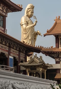Bangkok, Thailand - Apr 11, 2024 - Big Golden statue goddess of Mercy Guanyin or Quan Yin statue at Fo Guang Shan Thaihua Temple. Guan Yin Buddha, Taiwanese temple style, Space for text, Selective focus.