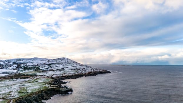 Aerial view of snow covered Dunmore Head, Bunaninver and Lackagh by Portnoo in County Donegal, Ireland