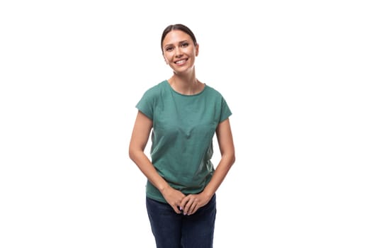 pretty smiling young brunette woman in green t-shirt isolated on white background.