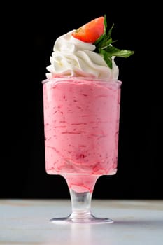 Mousse dessert with cream in glass on the table close up