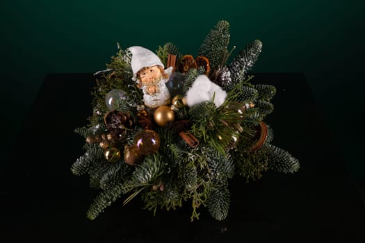 A variety of Christmas decorations such as ornaments, garlands, and lights are arranged neatly on a table, creating a festive and cheerful display. The decorations reflect the holiday spirit with their colorful and shiny appearances.