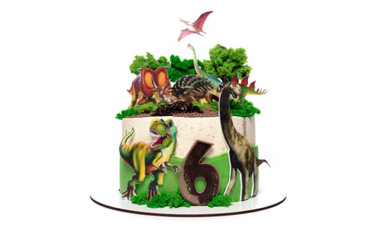 A birthday cake adorned with edible dinosaurs and plant decorations, perfect for a dinosaur-themed celebration. The cake features intricate details of different dinosaur species and lush green plant elements, creating a unique and fun design for the occasion.