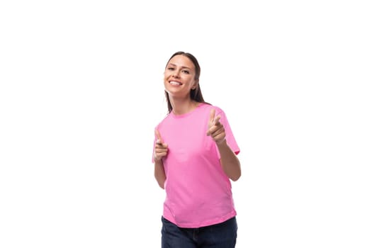 young charismatic good-looking woman with black hair is wearing a pink t-shirt on a white background with copy space.