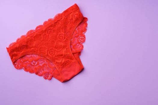 Women's panties on pink background with copy space flat lay