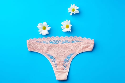 Women's panties with flower buds on paper background studio shot