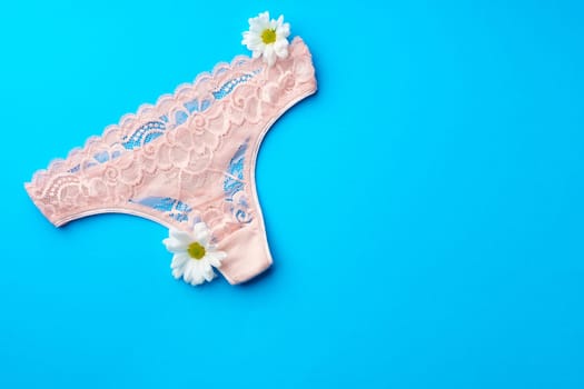 Women's panties with flower buds on paper background studio shot