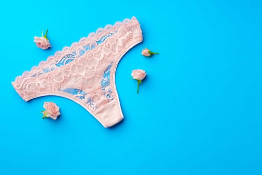 Women's panties with flower buds on paper background studio shot