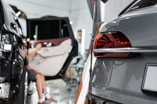 Car wrapping process, close up photo of man putting interior car protective film on car door