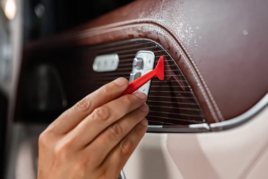 Car wrapping process, close up photo of man putting interior car protective film on car door